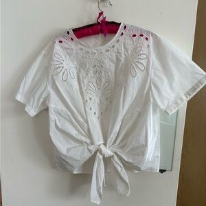 White eyelet cut out blouse. Front tie back button up.